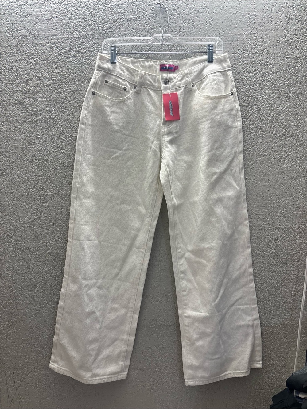 Edikted Wide-Leg White Jeans with Pink Brand Tag